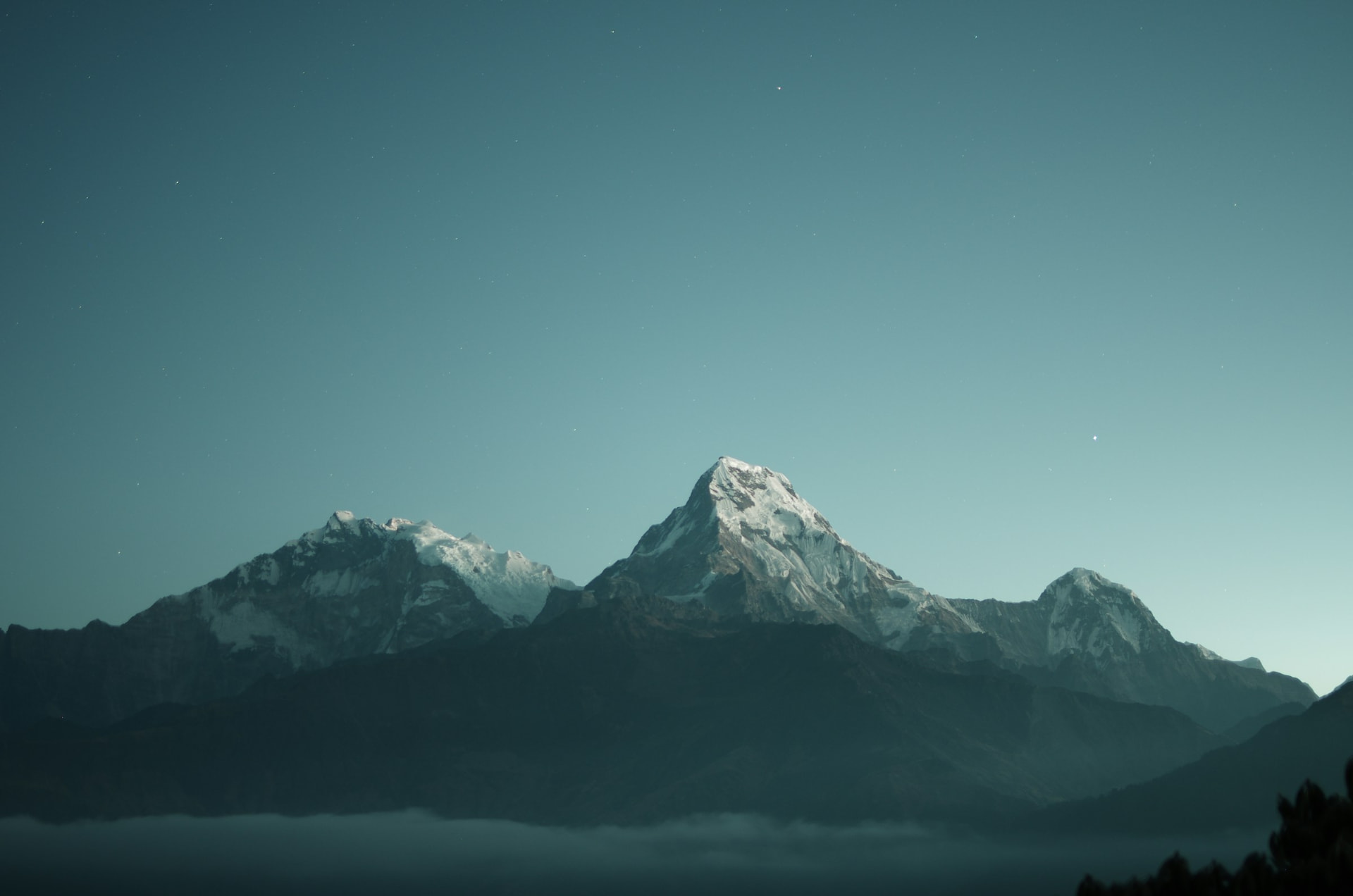 Sunlit river gorge and misty forested ridges in north bengal at dawn